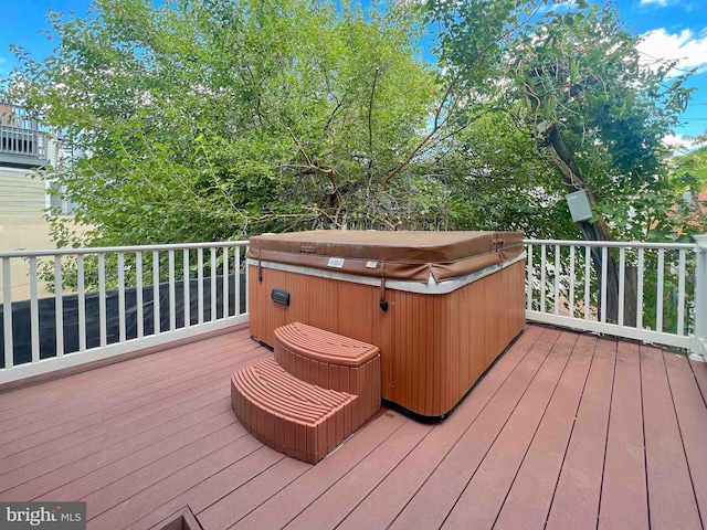 wooden terrace with a hot tub