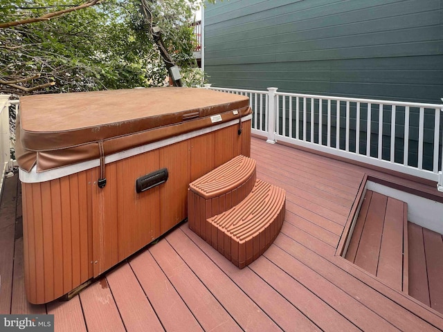 wooden deck featuring a hot tub