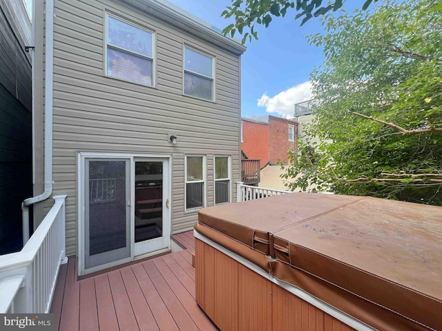 wooden deck with a hot tub