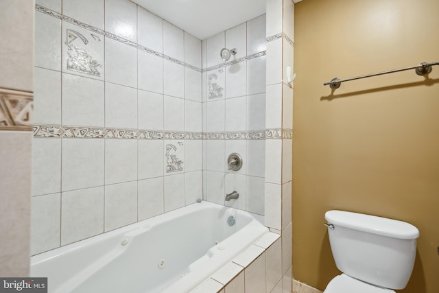 bathroom with toilet and a combined bath / shower with jetted tub