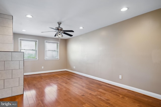 spare room featuring ceiling fan, recessed lighting, wood finished floors, and baseboards