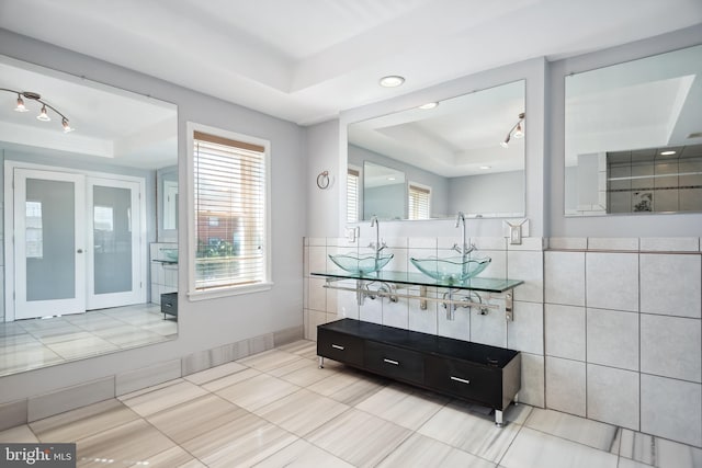 bathroom featuring a tray ceiling and vanity