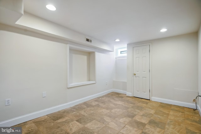 below grade area featuring recessed lighting, visible vents, and baseboards