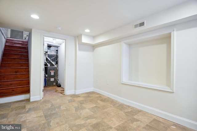 finished basement with baseboards, stairs, visible vents, and recessed lighting