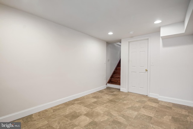 finished below grade area featuring stairway, recessed lighting, and baseboards