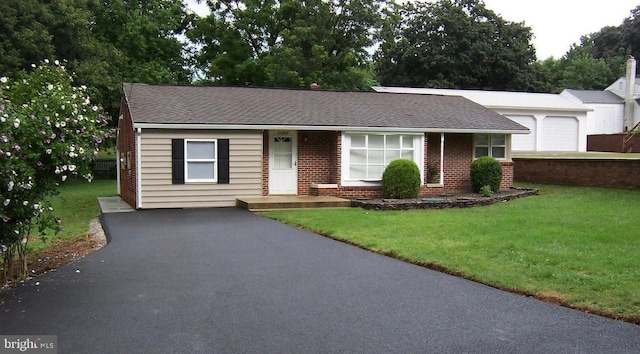 single story home with a garage and a front lawn