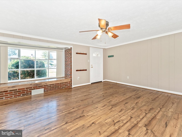 spare room with ceiling fan, hardwood / wood-style flooring, ornamental molding, and a textured ceiling