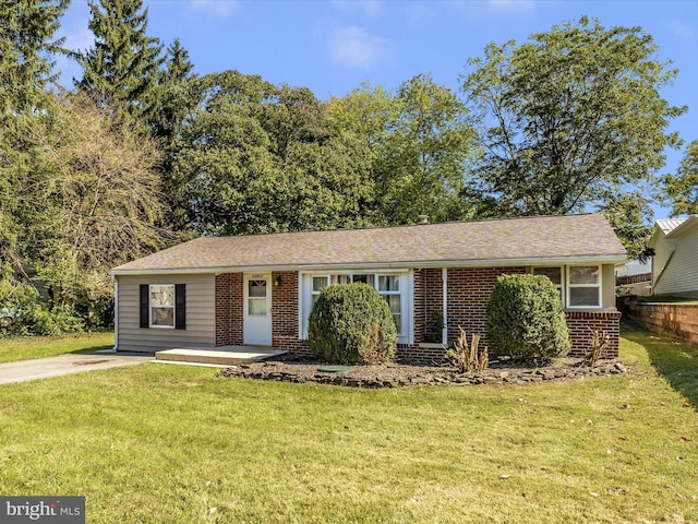 ranch-style home with brick siding and a front yard