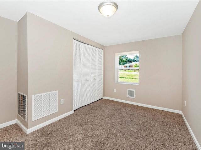 unfurnished bedroom with a closet and carpet