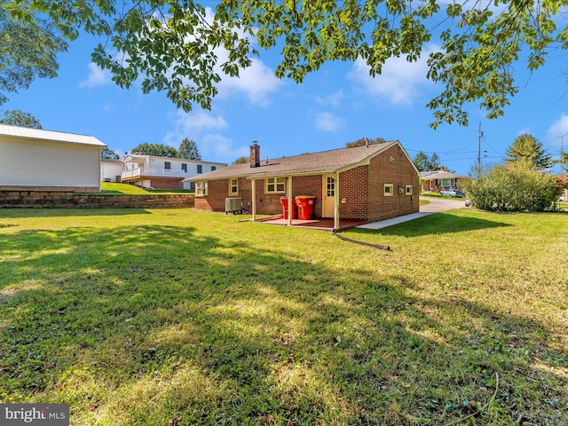 view of yard with central AC unit and a patio