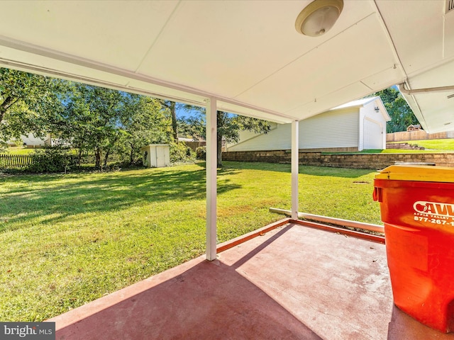 view of yard featuring a shed and a patio area