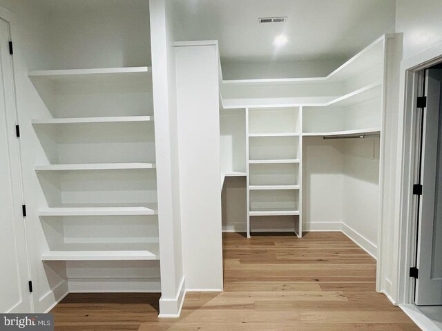 walk in closet featuring hardwood / wood-style flooring