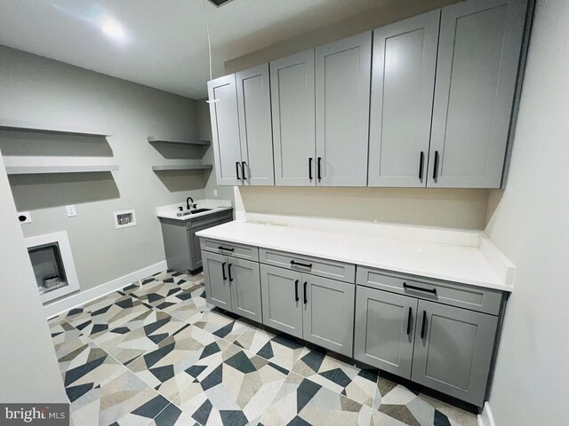 laundry room featuring cabinets, hookup for a washing machine, and sink