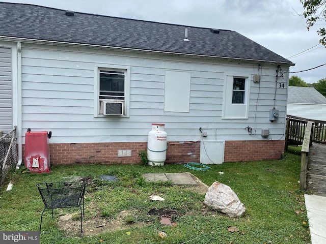 rear view of property with cooling unit and a yard