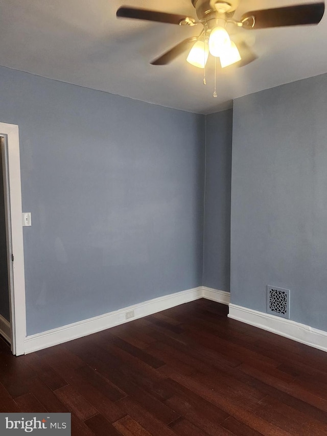 unfurnished room with ceiling fan and dark hardwood / wood-style flooring