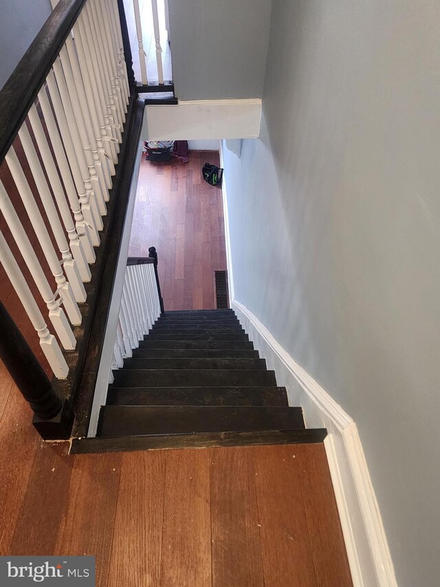 stairs featuring hardwood / wood-style flooring