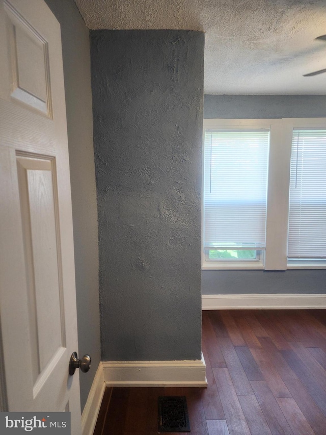 interior space featuring a textured ceiling and hardwood / wood-style floors