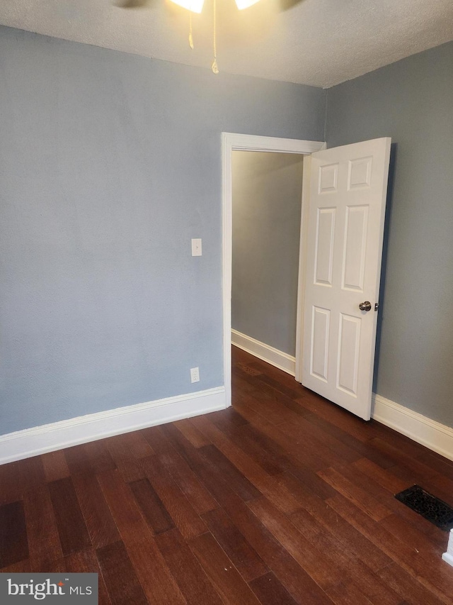 unfurnished room featuring ceiling fan and hardwood / wood-style flooring