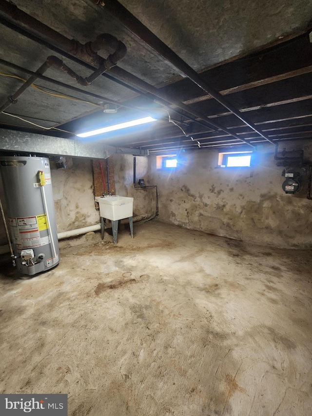 basement featuring sink and water heater