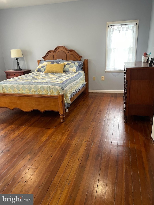 bedroom with dark wood-type flooring