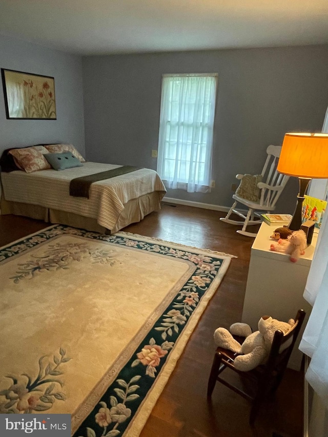 bedroom with dark wood-type flooring