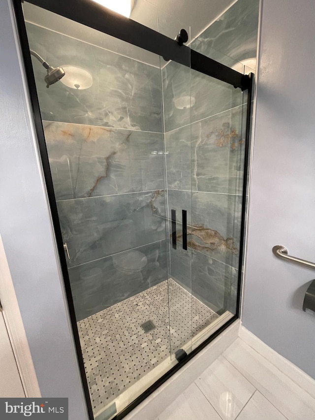 bathroom featuring tile patterned floors and a shower with door