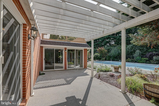 view of patio with an outdoor pool and a pergola