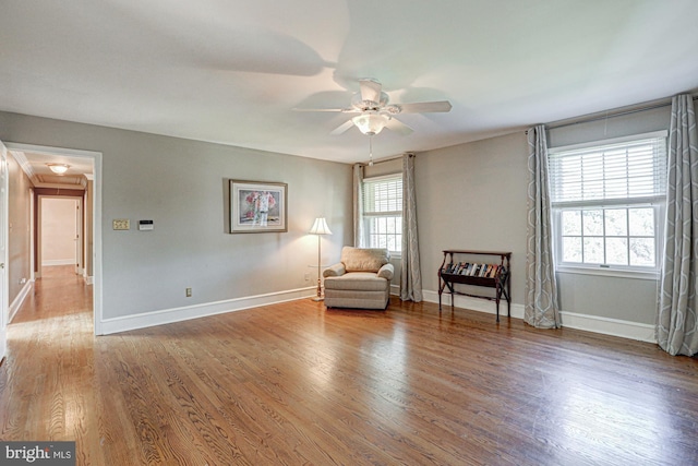 unfurnished room featuring a ceiling fan, baseboards, and wood finished floors