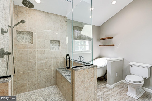 full bathroom with a stall shower, baseboards, toilet, a soaking tub, and recessed lighting