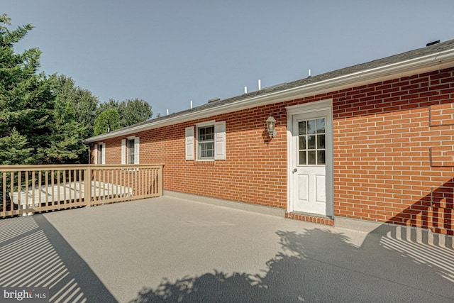 doorway to property with brick siding