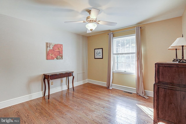 sitting room featuring light wood-style floors, ceiling fan, and baseboards