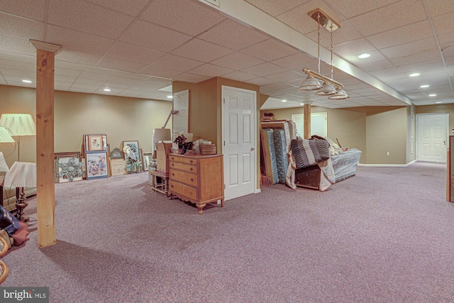 finished basement with a paneled ceiling, carpet, baseboards, and recessed lighting