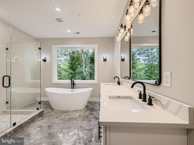 bathroom with tile patterned floors, separate shower and tub, and vanity