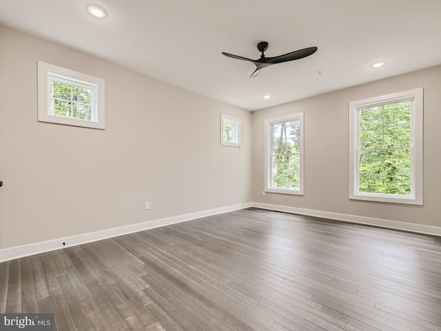 spare room with ceiling fan, recessed lighting, dark wood finished floors, and baseboards