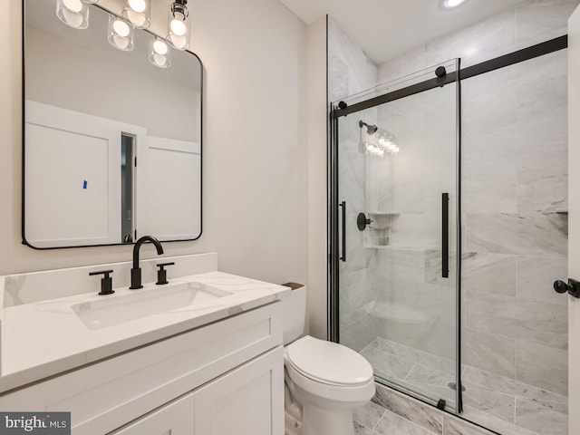 bathroom with tile patterned floors, toilet, an enclosed shower, and vanity