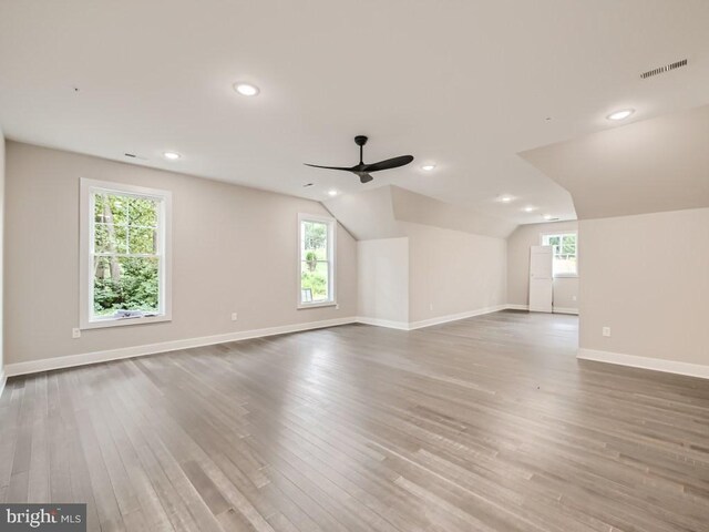 interior space featuring ceiling fan, lofted ceiling, hardwood / wood-style floors, and a healthy amount of sunlight