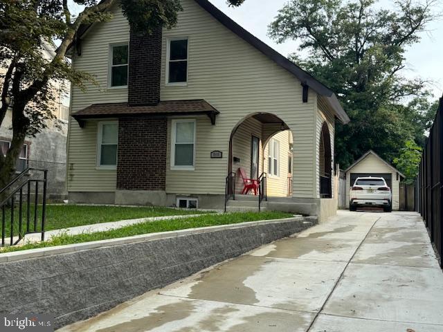 view of front of house featuring a garage and an outdoor structure