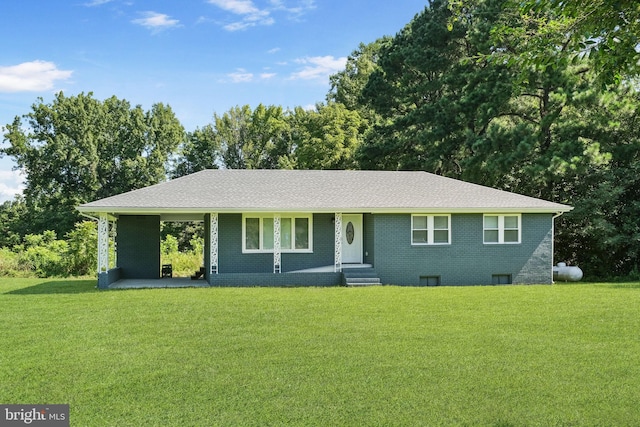 single story home with a carport, brick siding, and a front lawn