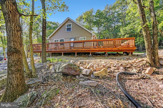 rear view of house featuring a deck