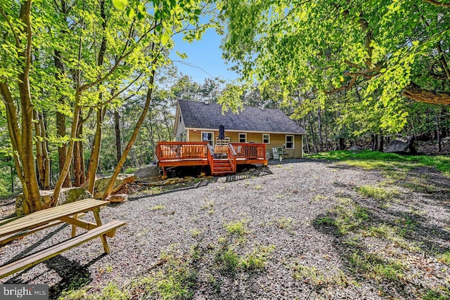 back of house with a wooden deck