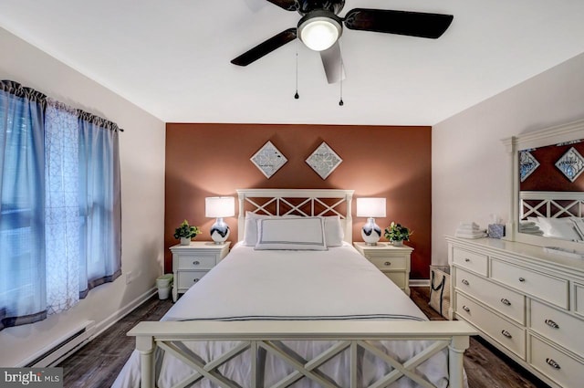 bedroom featuring ceiling fan, dark wood-type flooring, and a baseboard heating unit