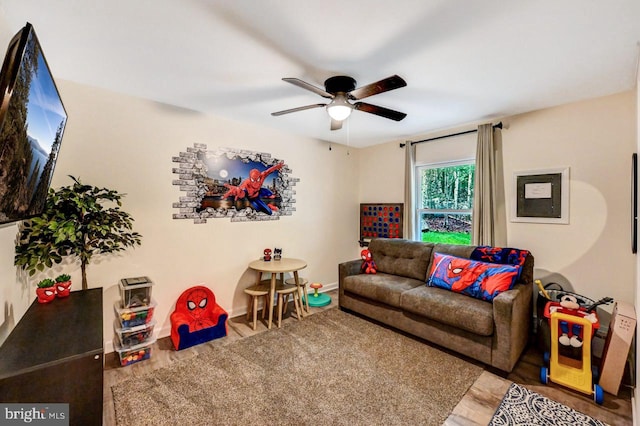 living room with ceiling fan and hardwood / wood-style floors