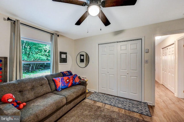 living room featuring ceiling fan and light hardwood / wood-style flooring