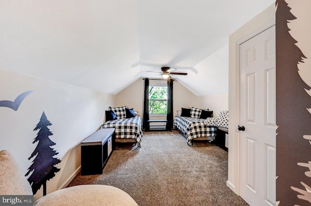 bedroom with ceiling fan, dark carpet, and lofted ceiling