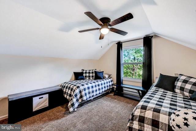 bedroom with dark colored carpet, vaulted ceiling, and ceiling fan