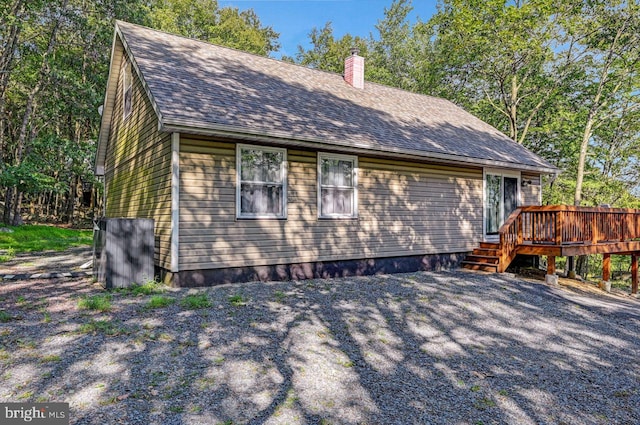 view of home's exterior with a wooden deck