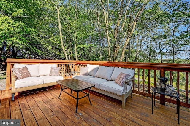 wooden terrace featuring outdoor lounge area