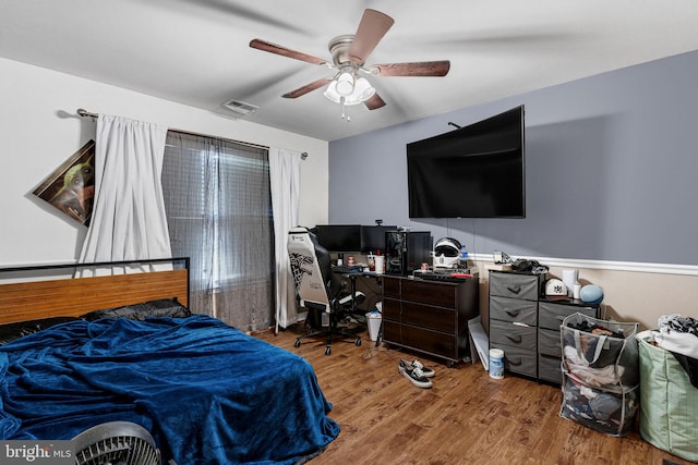 bedroom featuring hardwood / wood-style floors and ceiling fan