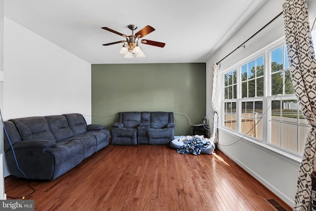 living room featuring ceiling fan and wood-type flooring