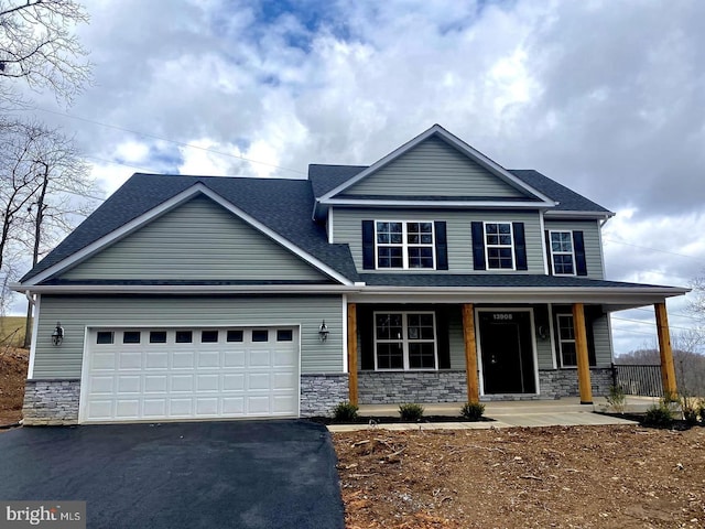 craftsman-style home featuring a porch and a garage